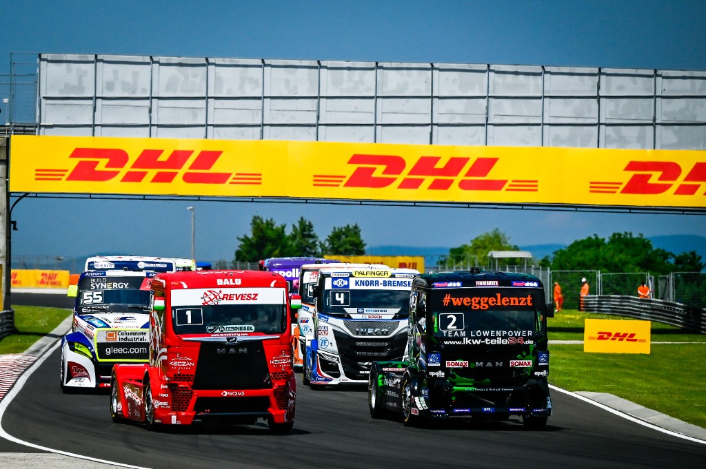 Racing trucks pack under the DHL bridge at the Hungaroring