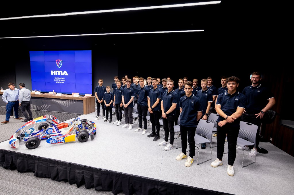 Hungarian Motorsport Academy cohort on stage with a go-kart