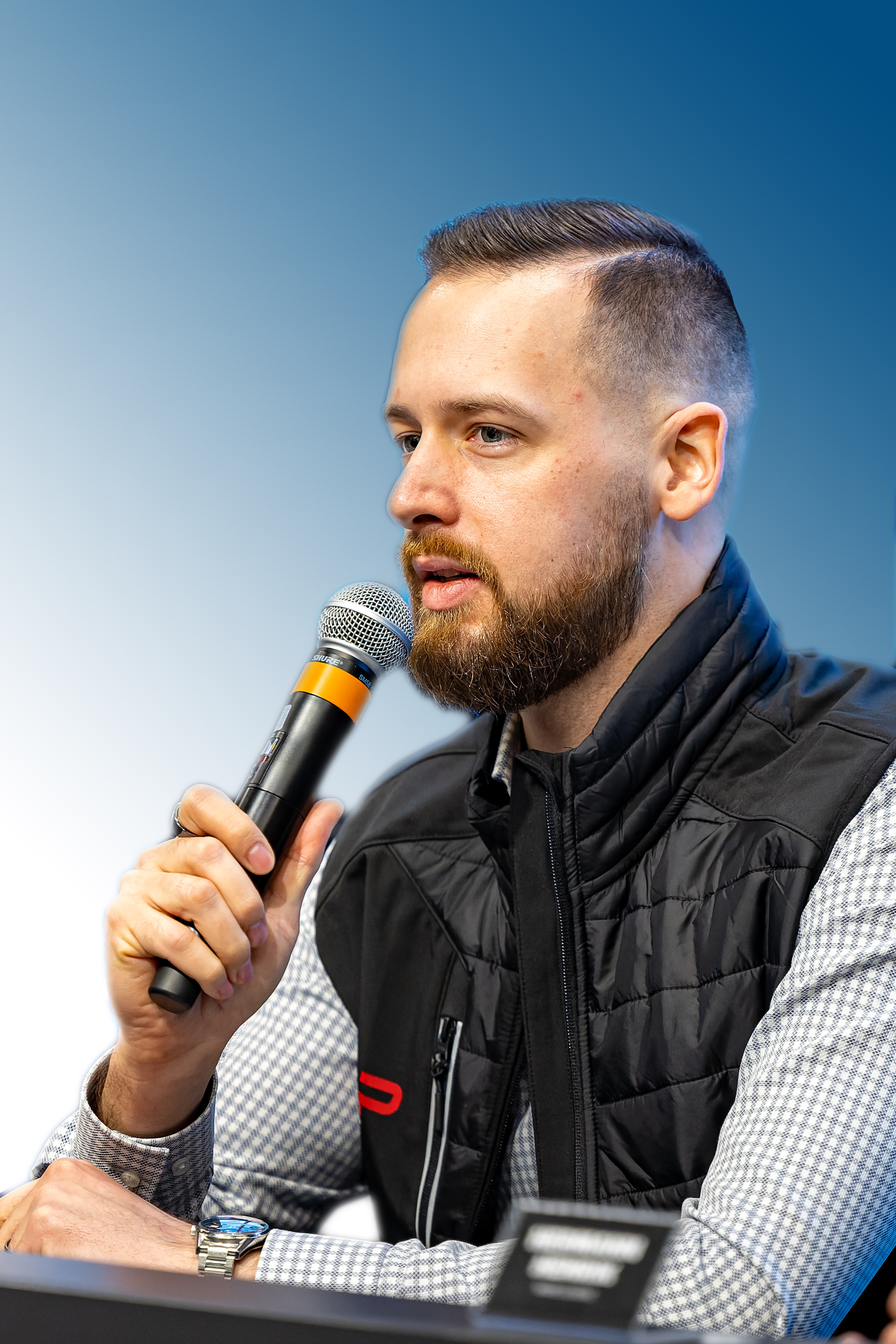 Kornel Ory speaking at a motorsport event
