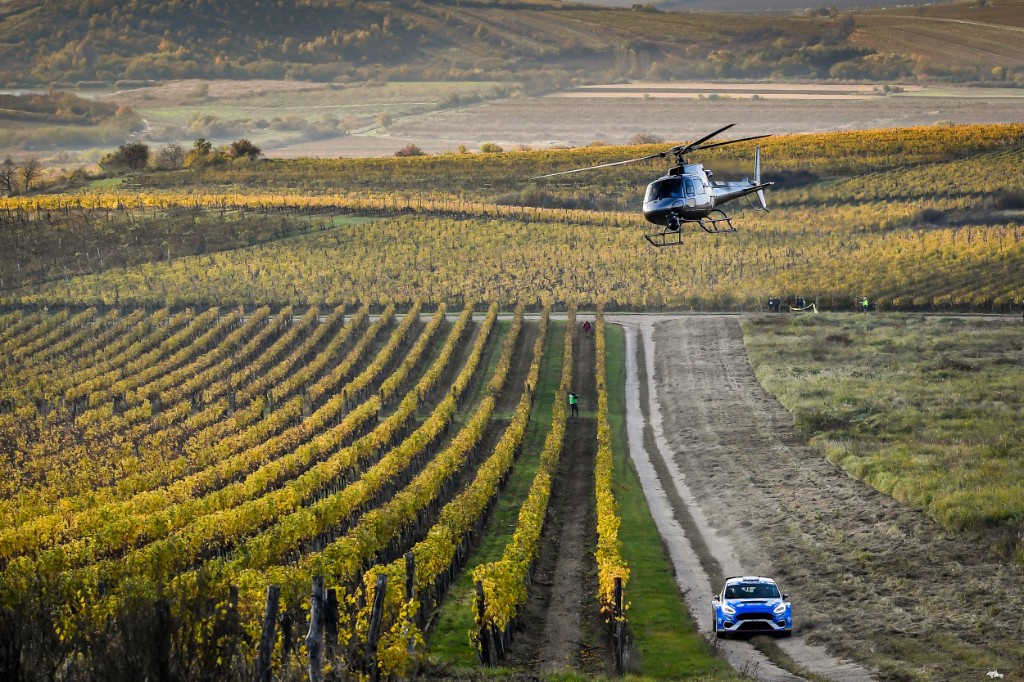 Rally car and filming helicopter over vineyards during Rally Hungary